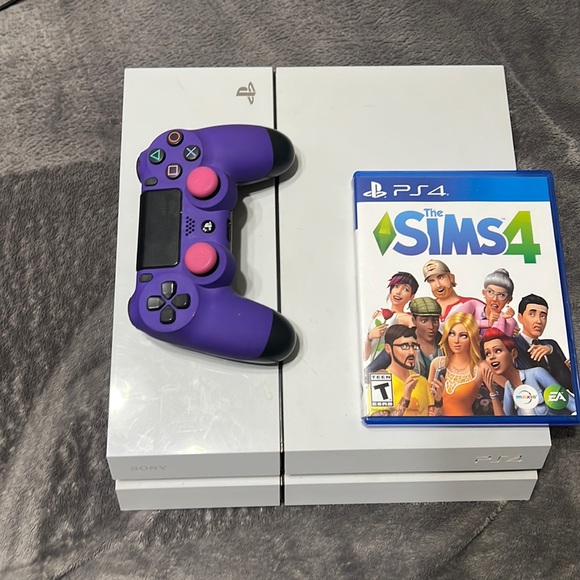 PS4 1 controller and Sims 4 game.